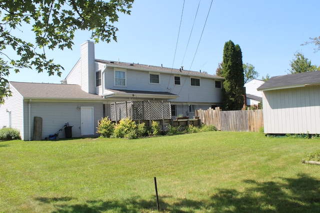 29352 Medburn Ct, Farmington Hills, MI 48336 - back of house with a lawn, a chimney, and fence