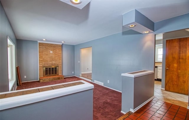 unfurnished living room with dark tile patterned flooring and a fireplace