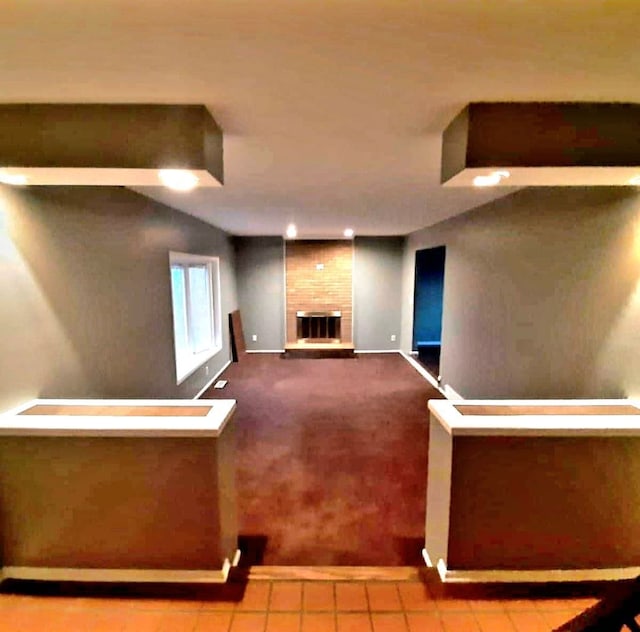 unfurnished living room with tile patterned flooring and a fireplace