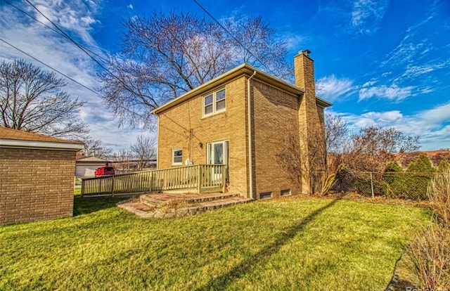 rear view of property featuring a lawn