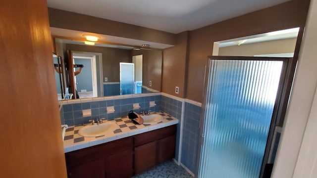 bathroom featuring vanity and tile walls