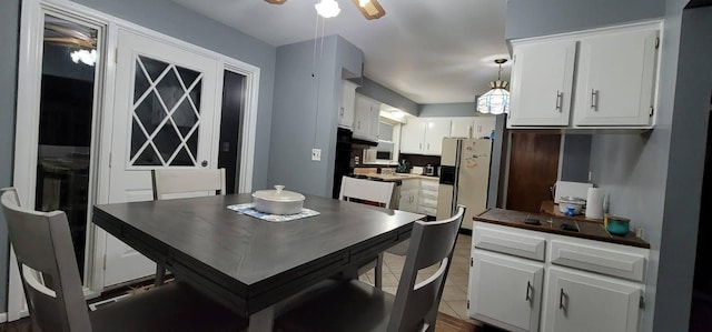 tiled dining room with ceiling fan