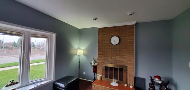 living room featuring a brick fireplace