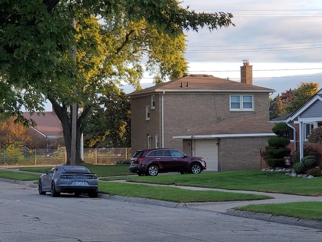 view of side of home featuring a lawn and a garage