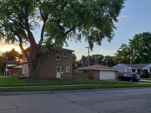 view of front of home with a yard and a garage