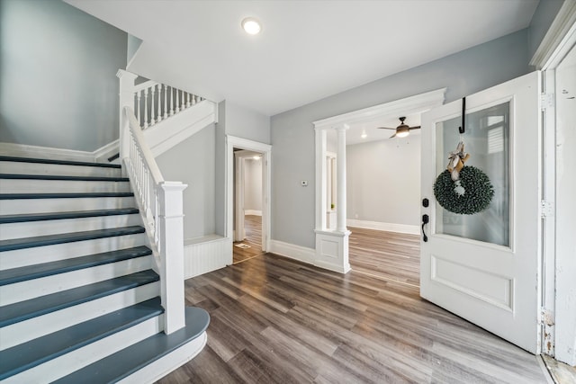 entryway featuring decorative columns, ceiling fan, and hardwood / wood-style flooring