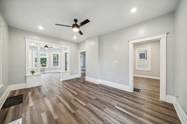 unfurnished living room with ceiling fan and wood-type flooring