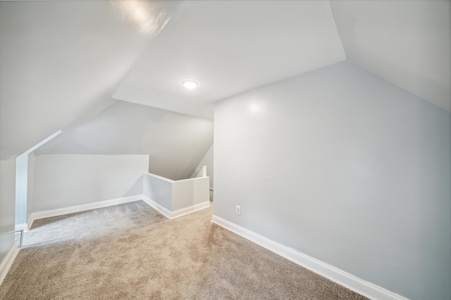 additional living space with light carpet and lofted ceiling