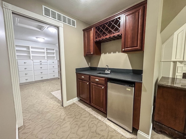 kitchen featuring sink, light colored carpet, and appliances with stainless steel finishes