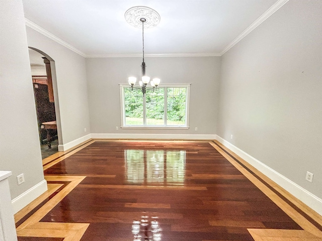 unfurnished dining area featuring wood-type flooring, crown molding, and a chandelier