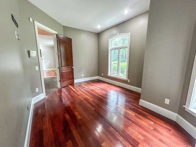 unfurnished room with hardwood / wood-style floors