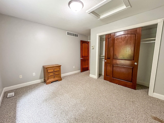 unfurnished bedroom with light colored carpet and a closet