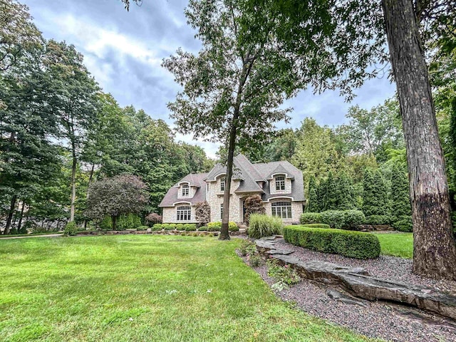 french country home featuring a front lawn