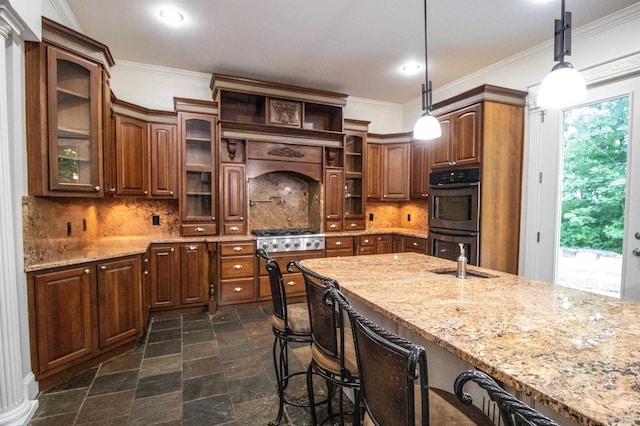 kitchen featuring pendant lighting, double oven, and ornamental molding