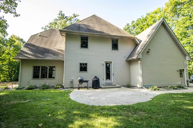 back of house with a lawn and a patio area