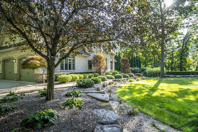 view of front of house with a garage and a front lawn