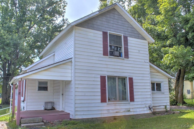 rear view of property with a yard and covered porch