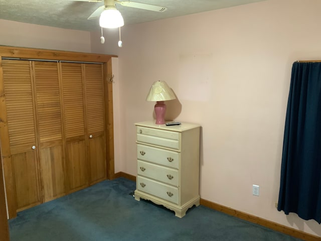 bedroom featuring dark colored carpet, a closet, and ceiling fan