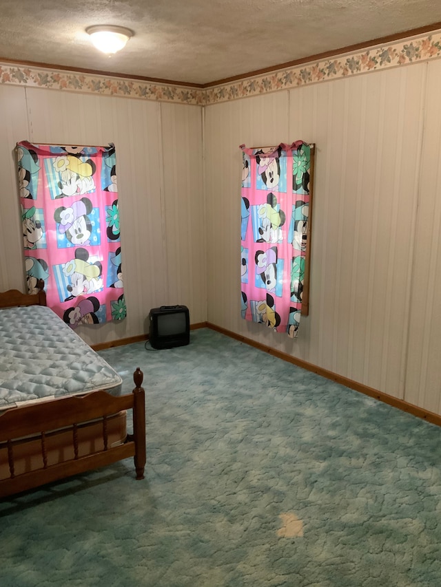 bedroom featuring dark colored carpet and a textured ceiling