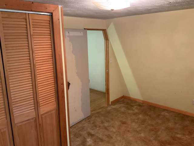 interior space featuring carpet and a textured ceiling