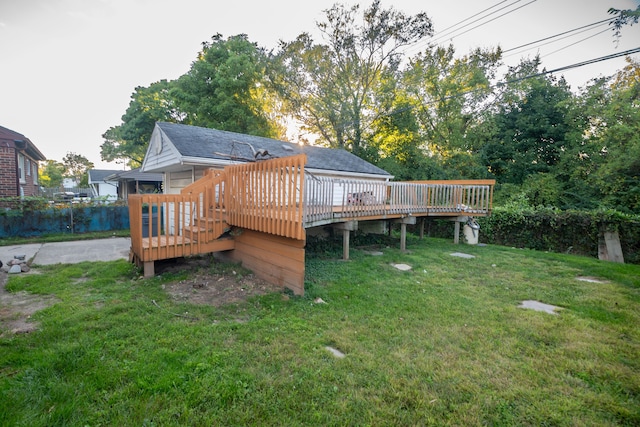 back of property with a lawn and a wooden deck