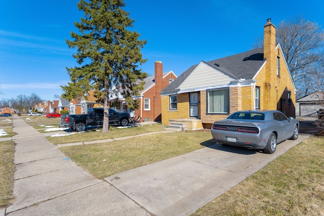 bungalow-style house featuring a front yard