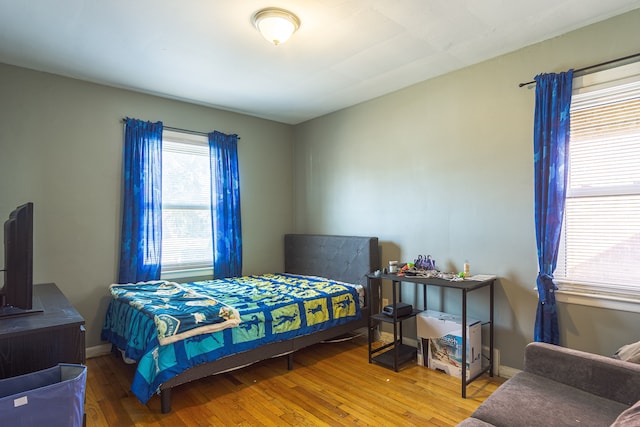 bedroom with hardwood / wood-style flooring