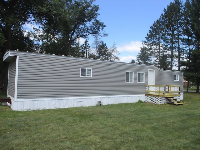 view of home's exterior featuring a lawn and a wooden deck