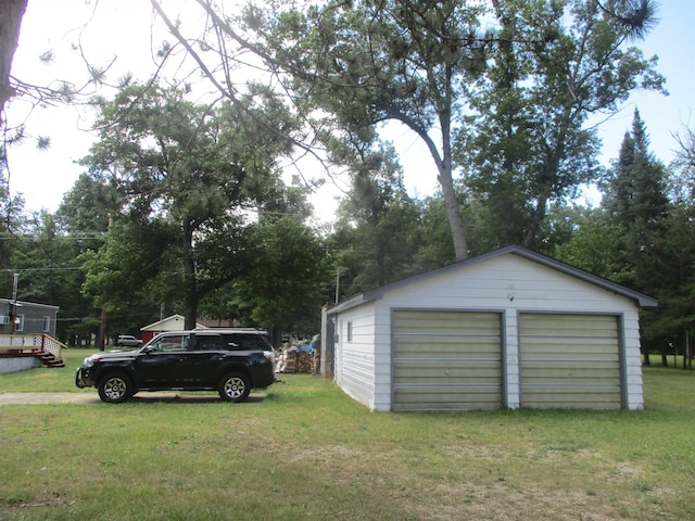 garage featuring a lawn