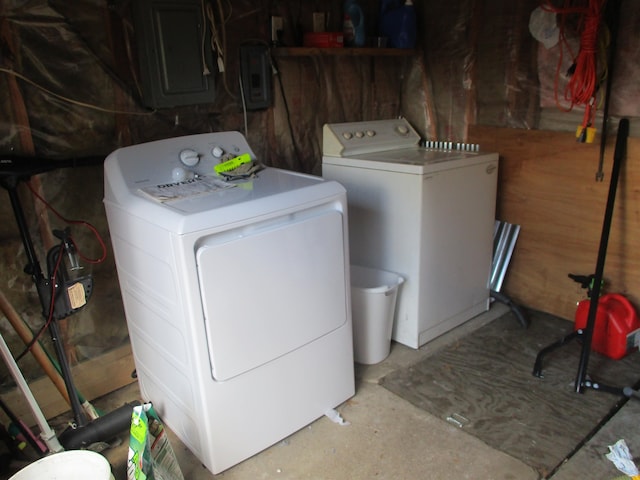 clothes washing area with electric panel and separate washer and dryer