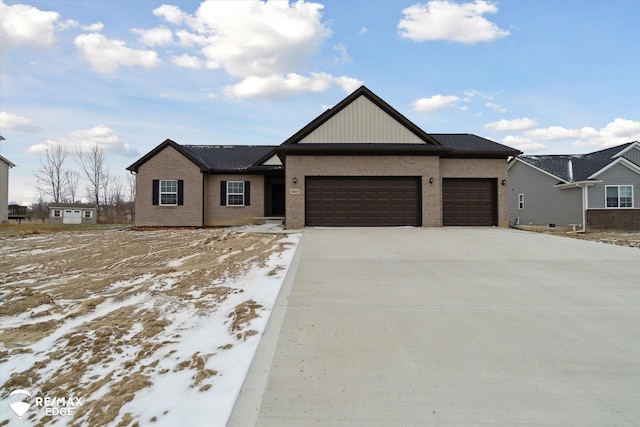 ranch-style house with an attached garage, concrete driveway, and brick siding