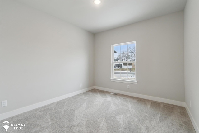 carpeted spare room with recessed lighting, visible vents, and baseboards