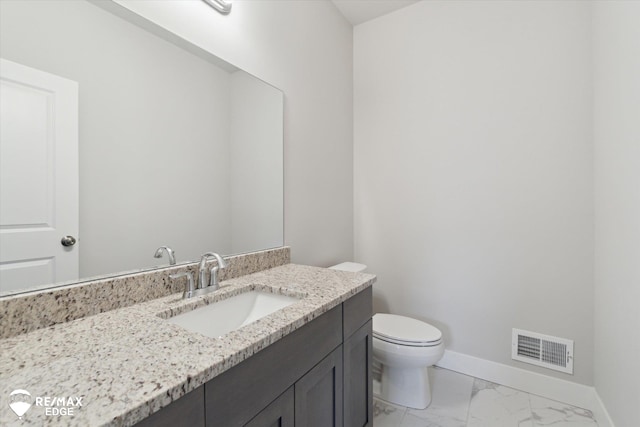 half bathroom with marble finish floor, baseboards, visible vents, and vanity