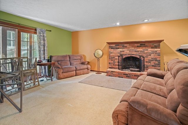 living room featuring carpet floors, a textured ceiling, and a brick fireplace