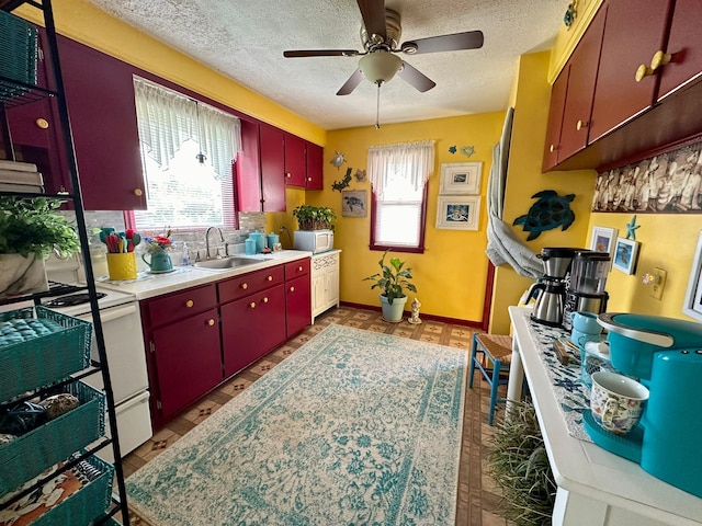 12841 Telegraph Rd, Taylor, MI 48180 - kitchen with red cabinetry, white appliances, a textured ceiling, ceiling fan, and light countertops
