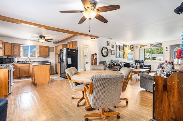 dining area with plenty of natural light, ceiling fan, sink, and light hardwood / wood-style flooring