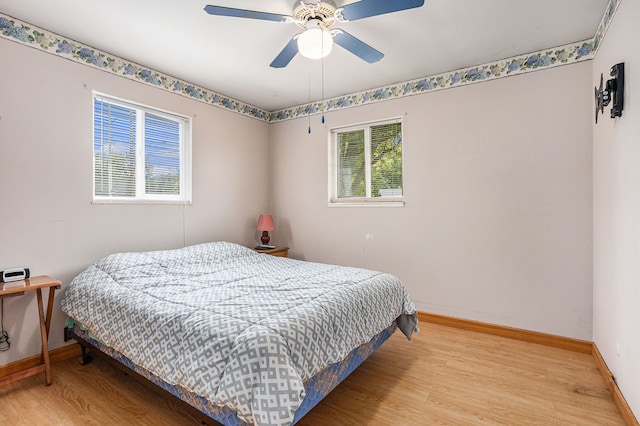 bedroom featuring light hardwood / wood-style floors and ceiling fan