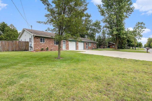 ranch-style house featuring a garage and a front lawn