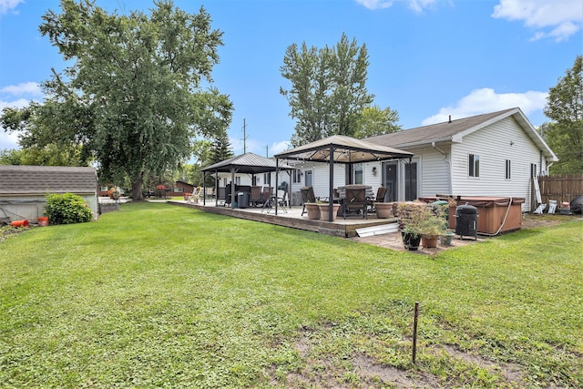 back of property with a gazebo and a lawn