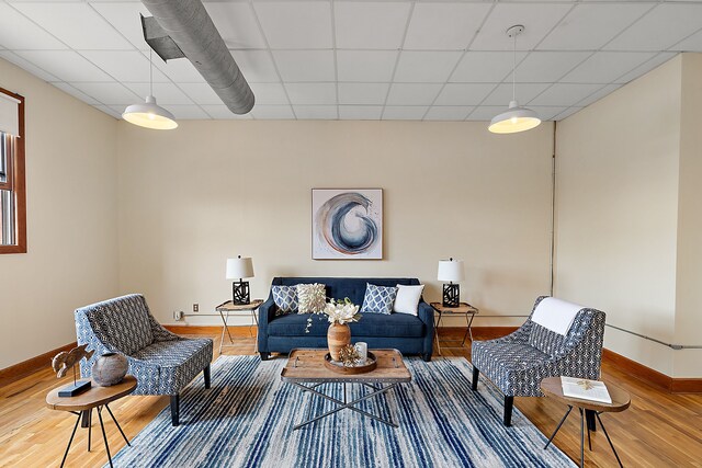 1395 Antietam Ave Unit 51, Detroit, MI 48207 - living area featuring baseboards, wood finished floors, and a drop ceiling