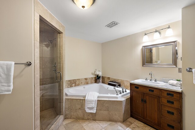 1395 Antietam Ave Unit 51, Detroit, MI 48207 - bathroom featuring vanity, a stall shower, a garden tub, and tile patterned floors
