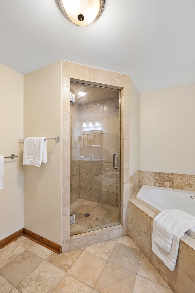 1395 Antietam Ave Unit 51, Detroit, MI 48207 - bathroom with a bath, a stall shower, stone tile floors, and baseboards