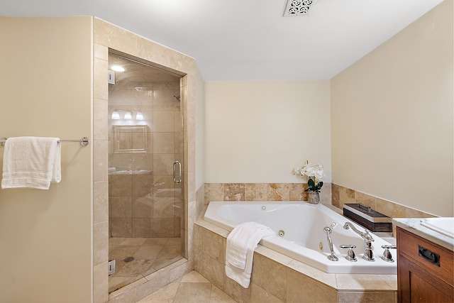 bathroom with tile patterned floors, vanity, and shower with separate bathtub