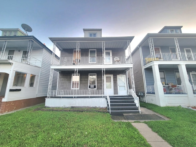 view of front facade featuring covered porch and a lawn