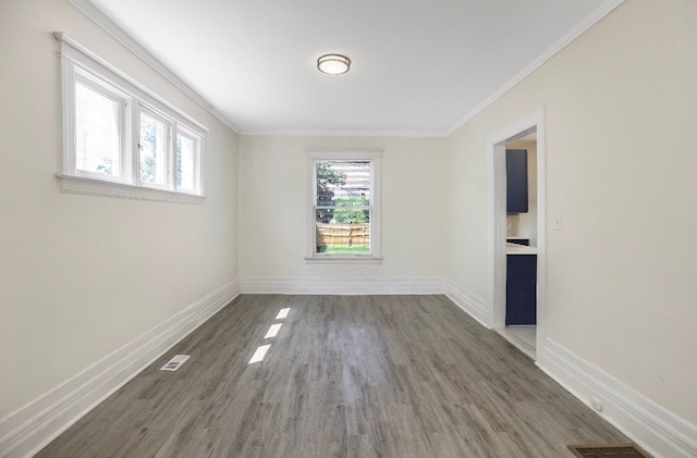 spare room featuring crown molding and dark wood-type flooring