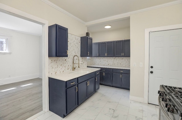 kitchen featuring sink, light hardwood / wood-style flooring, crown molding, decorative backsplash, and stainless steel range with gas stovetop