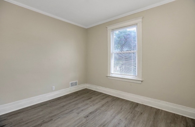 spare room with wood-type flooring and ornamental molding