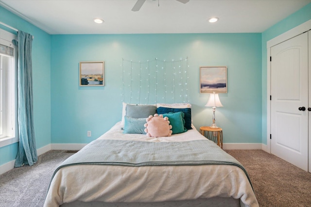 carpeted bedroom featuring ceiling fan, a closet, and multiple windows