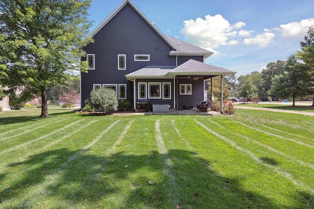 back of property featuring a lawn