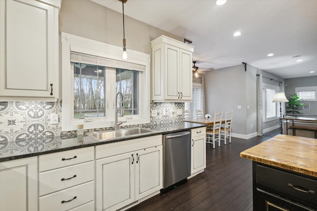 kitchen with white cabinetry, dishwasher, sink, dark hardwood / wood-style flooring, and decorative backsplash